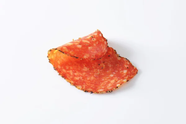 Black pepper-coated salami with cheese — Stock Photo, Image