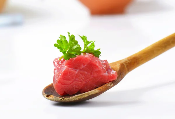 Raw beef meat on wooden spoon — Stock Photo, Image
