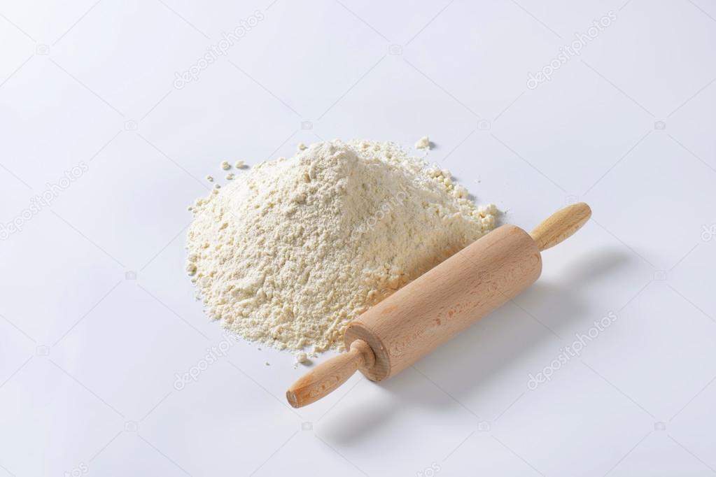 Pile of wheat flour and rolling pin