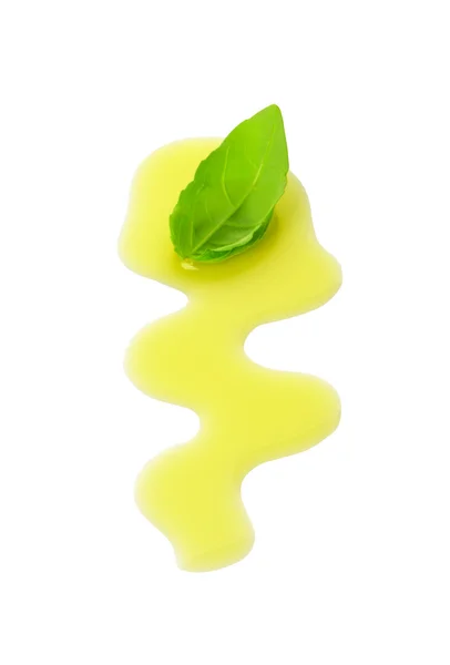 Olive oil drizzle and basil leaf — Stock Photo, Image