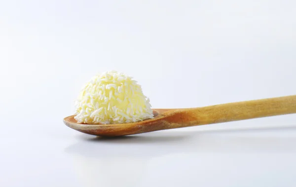 Coconut truffle on wooden spoon — Stock Photo, Image