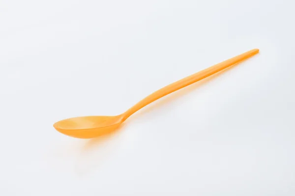 Oranje plastic lepel — Stockfoto