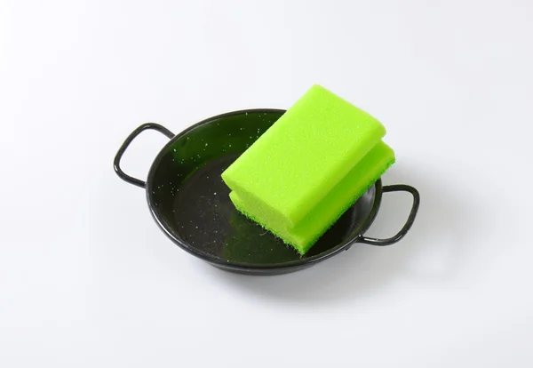 Kitchen sponge on skillet — Stock Photo, Image