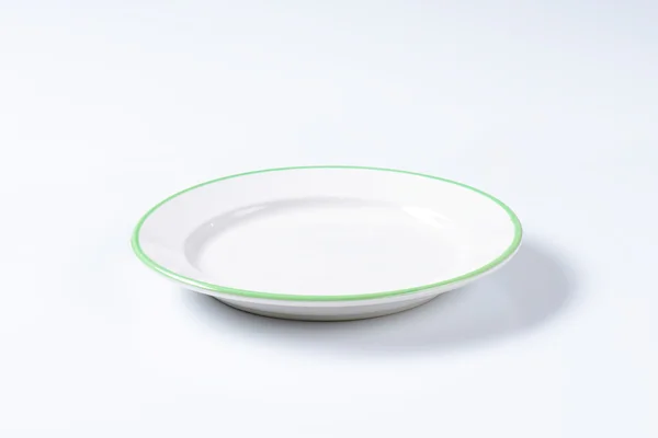 Empty rimmed dinner plate — Stock Photo, Image