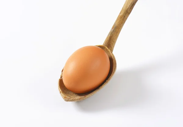 Brown egg on spoon — Stock Photo, Image