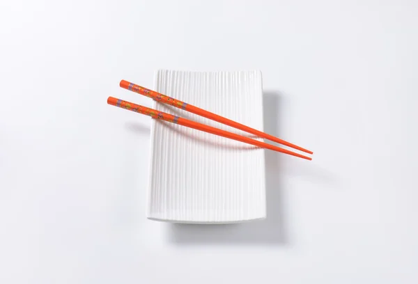 Chopsticks on plate — Stock Photo, Image