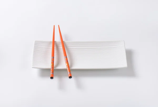 Chopsticks on plate — Stock Photo, Image