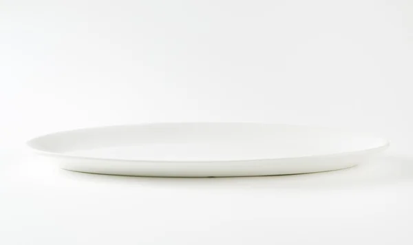 Empty oval white plate — Stock Photo, Image