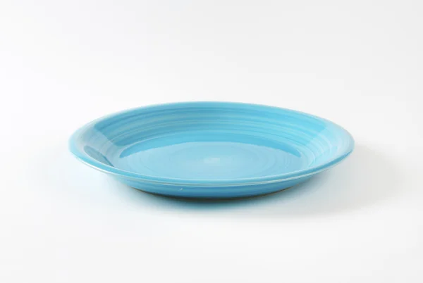 Rimless round blue ceramic plate — Stock Fotó