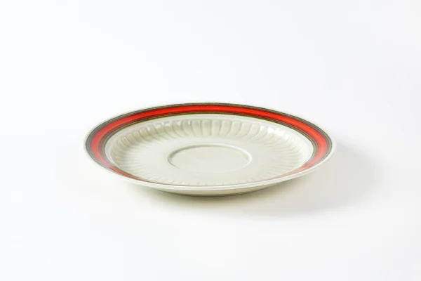 White saucer with red rim — Stock Photo, Image