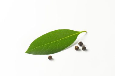 Fresh bay leaf and black peppercorns