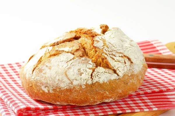 Crusty round loaf of bread — Stok fotoğraf