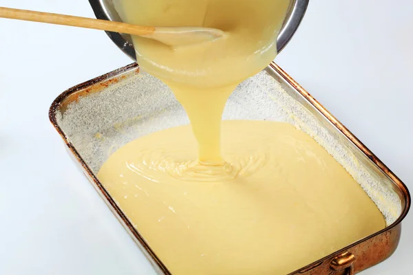 Pouring batter into baking pan — Stock Photo, Image