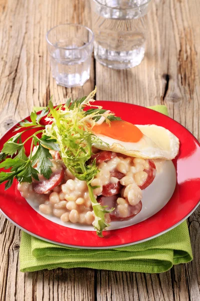 White beans with sausage and fried egg — Stock Photo, Image