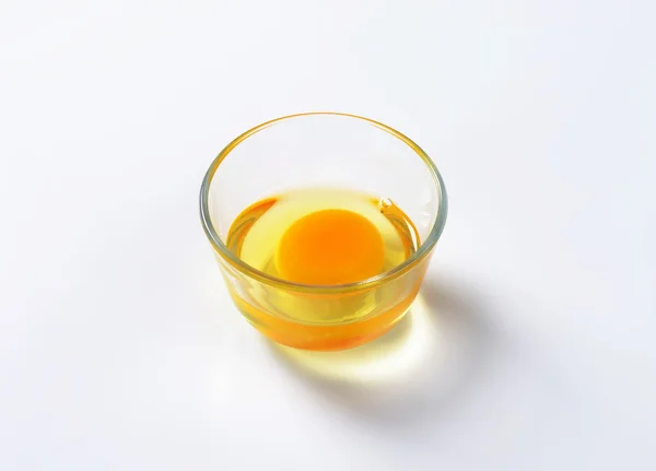 Egg white and yolk in glass bowl — Stock Photo, Image