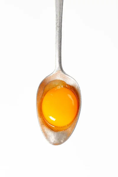 Raw egg yolk on spoon — Stock Photo, Image