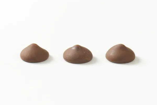 Chocolate chips on white background — Stock Photo, Image