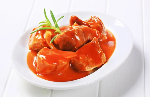 Pork meat in a tomato sauce — Stock Photo, Image