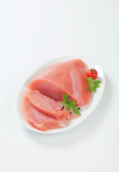 Raw turkey breast on plate — Stock Photo, Image