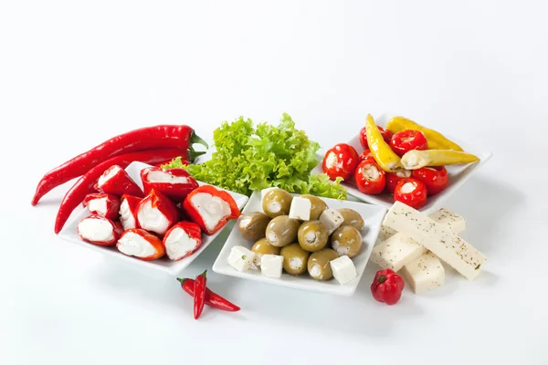 Cheese stuffed mini peppers and olives — Stock Photo, Image