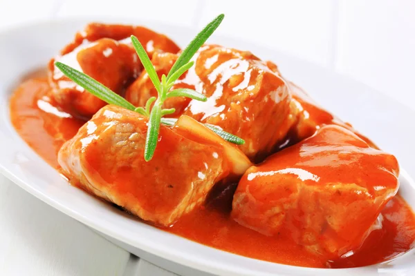 Pork meat in a tomato sauce — Stock Photo, Image