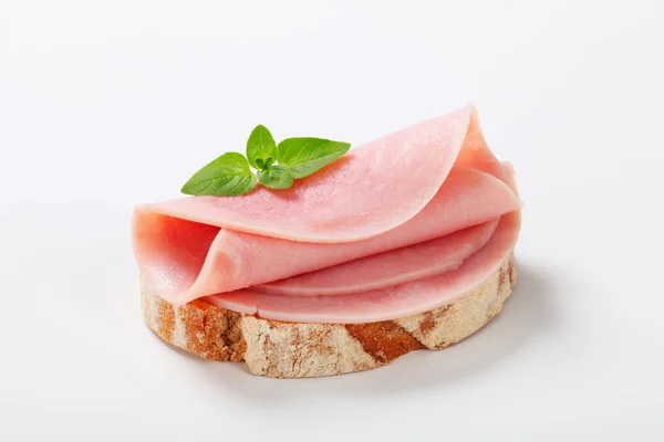 Slice of continental bread with ham — Stock Photo, Image