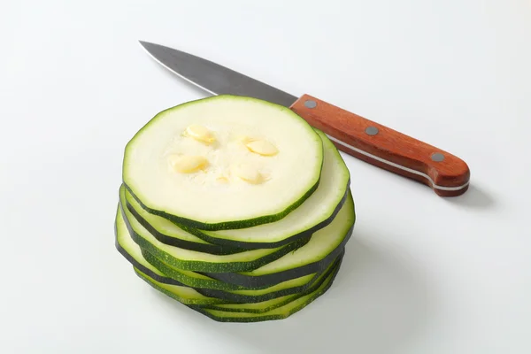 Stack of sliced zucchini with a knife — Stock Photo, Image