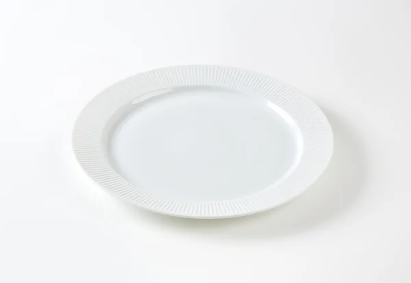 White plate with ribbed rim — Stock Photo, Image