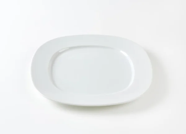 Wide rimmed square plate — Stock Photo, Image