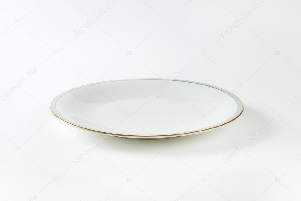 White plate with blue and gold band
