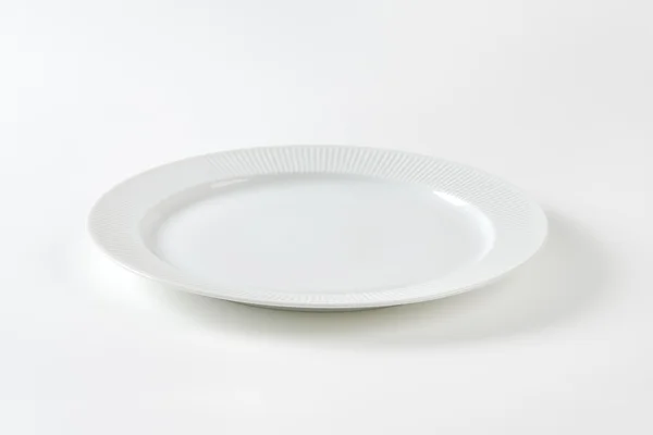 White plate with ribbed rim — Stock Photo, Image