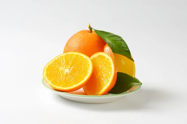 Fresh ripe oranges with leaves — Stock Photo, Image