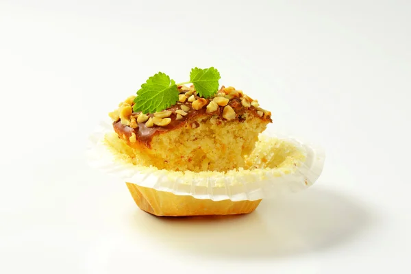 Hazelnut muffin - half eaten — Stock Photo, Image