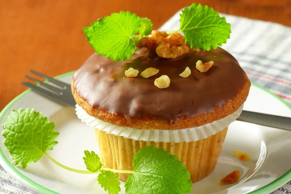 Chocolate glazed walnut muffin — Stock Photo, Image