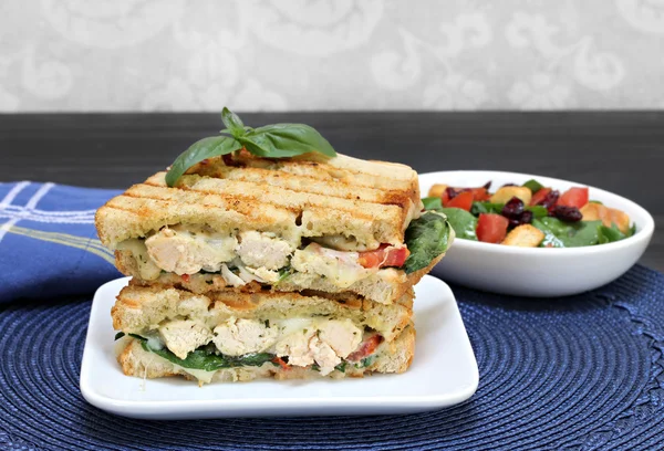 Hühnchen, Basilikum, Spinat, Tomaten, Pesto und Käsepanini. — Stockfoto