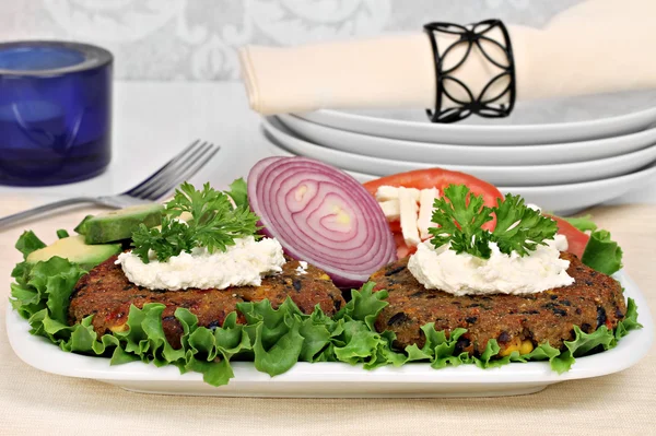 Black bean vegetarian burgers with a goat cheese topping. — Stock Photo, Image
