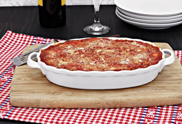 Full oval white baking  pan of baked eggplant or lasagna. — Stock Photo, Image