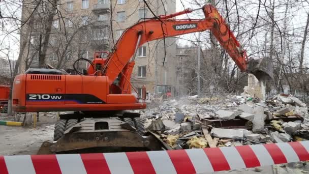 Grävmaskin maskiner som arbetar med rivning gamla hus. Moscow, Ryssland — Stockvideo