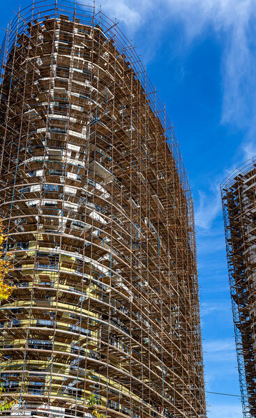 Multi-storey building under construction with scaffolding (new residential complex), Moscow, Russia