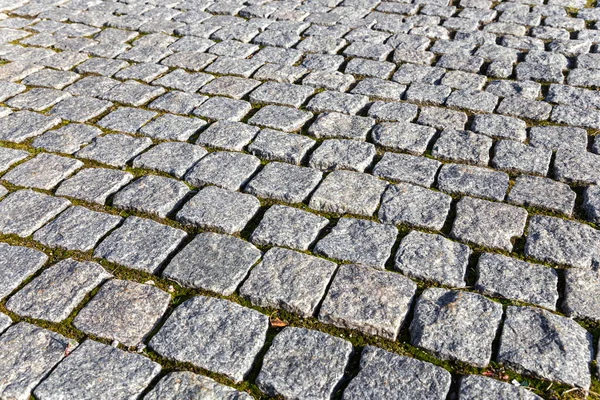 Yolun Eski Bir Granit Taşla Döşenmiş Parçası Arkaplan Olarak Kullanılabilir — Stok fotoğraf