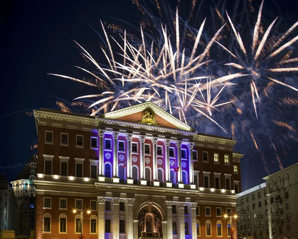 The building of the residence of the Mayor of Moscow with illumination at night, against the background of fireworks. Moscow, Russia