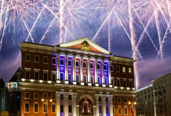 The building of the residence of the Mayor of Moscow with illumination at night, against the background of fireworks. Moscow, Russia