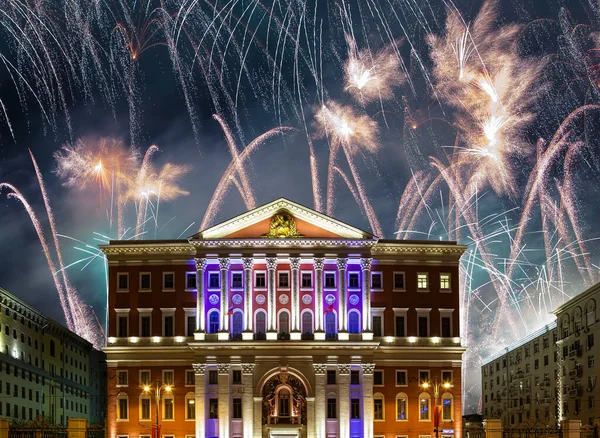 The building of the residence of the Mayor of Moscow with illumination at night, against the background of fireworks. Moscow, Russia