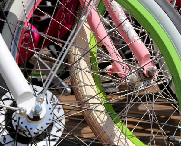 Row multicolored bicycle wheels closeup — Stock Photo, Image