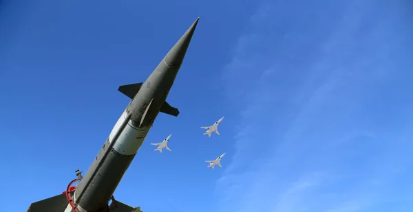 Modern Russian anti-aircraft missiles and military aircrafts fly in formation against the sky Stock Image