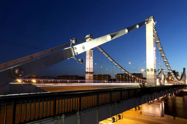 Krymsky Bridge or Crimean Bridge (night) is a steel suspension bridge in Moscow, Russia. The bridge spans the Moskva River 1,800 metres south-west from the Kremlin — Stock Photo, Image