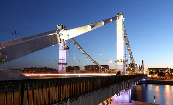 Krymsky Bridge or Crimean Bridge (night) is a steel suspension bridge in Moscow, Russia. The bridge spans the Moskva River 1,800 metres south-west from the Kremlin — Stock Photo, Image