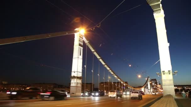 Krymsky Bridge of Krim Bridge en het verkeer van auto's (nacht)--is een stalen hangbrug in Moskou, Rusland. De brug overspant de Moskva rivier 1.800 meter ten zuidwesten van het Kremlin — Stockvideo