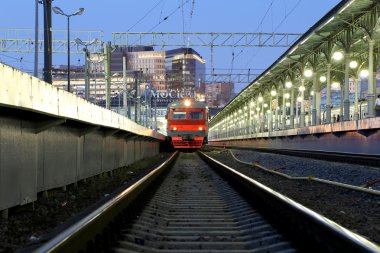 Train on Moscow passenger platform at night (Belorussky railway station) is one of the nine main railway stations in Moscow, Russia.