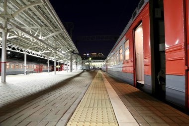 Train on Moscow passenger platform at night (Belorussky railway station) is one of the nine main railway stations in Moscow, Russia.